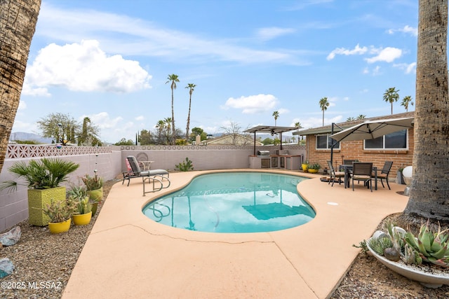 view of pool featuring outdoor dining area, a patio, a fenced in pool, and a fenced backyard