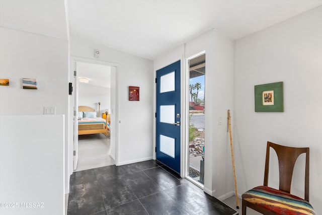 foyer featuring baseboards