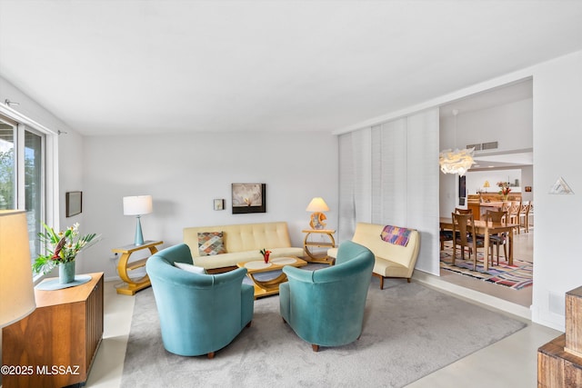 living area featuring visible vents and finished concrete floors