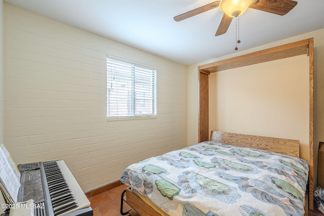 tiled bedroom featuring a ceiling fan