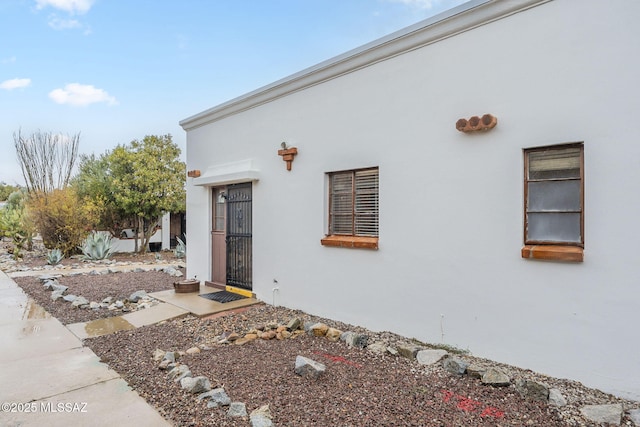 doorway to property with stucco siding