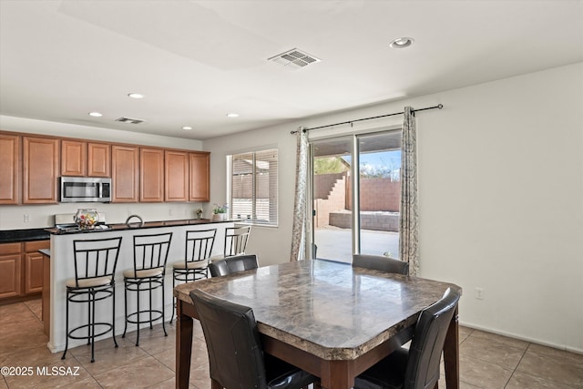 dining room featuring light tile patterned floors, recessed lighting, and visible vents