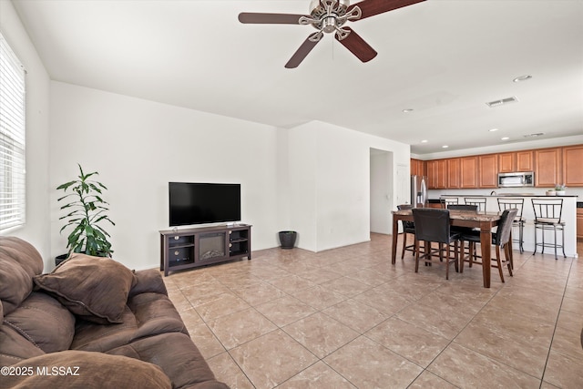 living area with light tile patterned flooring, recessed lighting, visible vents, and ceiling fan