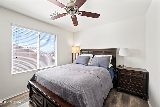 bedroom featuring a ceiling fan, baseboards, and wood finished floors