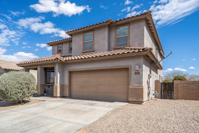 mediterranean / spanish-style house with stucco siding, driveway, an attached garage, and a tile roof