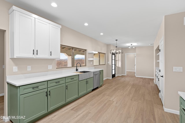 kitchen featuring green cabinetry, dishwasher, an inviting chandelier, white cabinets, and a sink