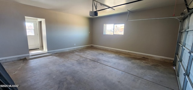 garage with baseboards and a garage door opener