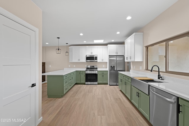 kitchen featuring a sink, white cabinets, stainless steel appliances, and green cabinetry