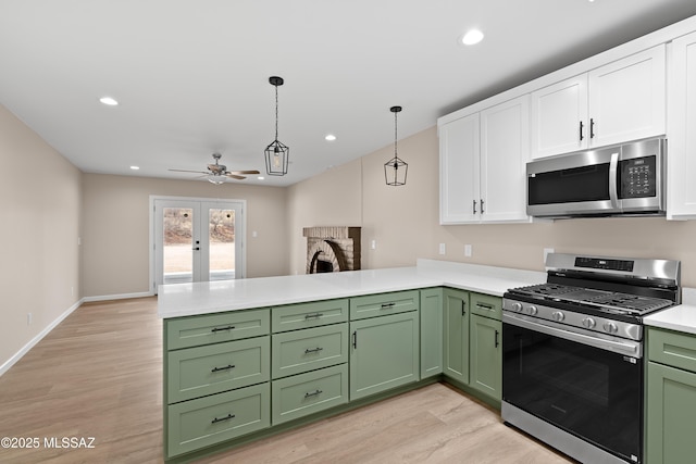 kitchen featuring green cabinets, light countertops, stainless steel appliances, white cabinetry, and a ceiling fan