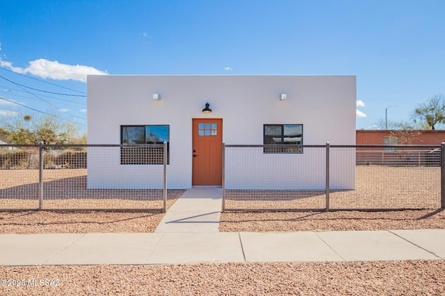 view of front of property with a fenced front yard and stucco siding