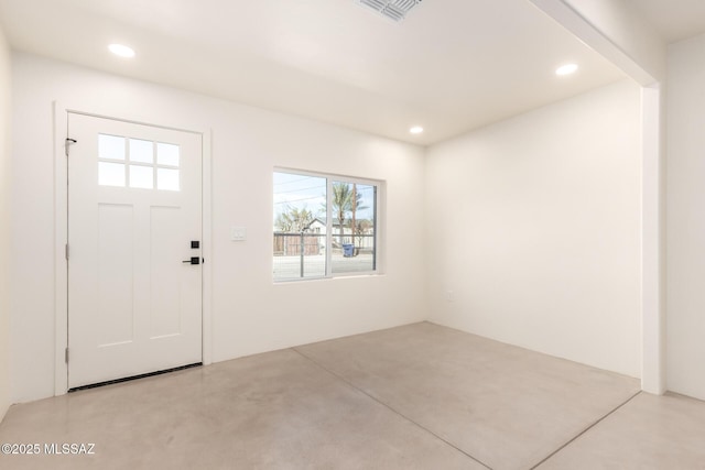 foyer entrance with recessed lighting, visible vents, and concrete floors