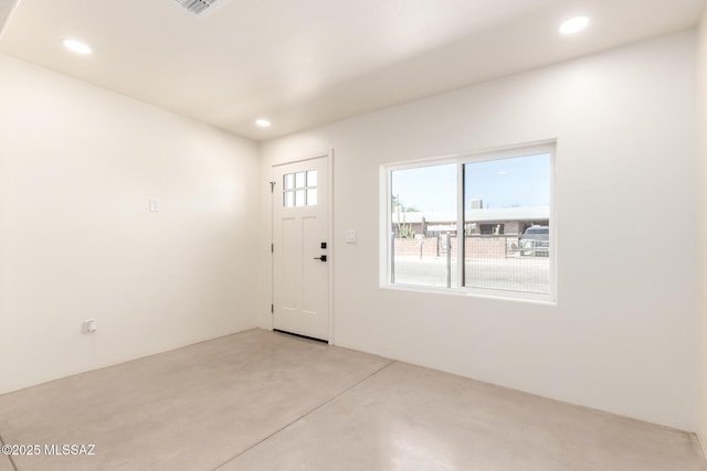 foyer entrance featuring recessed lighting and concrete floors