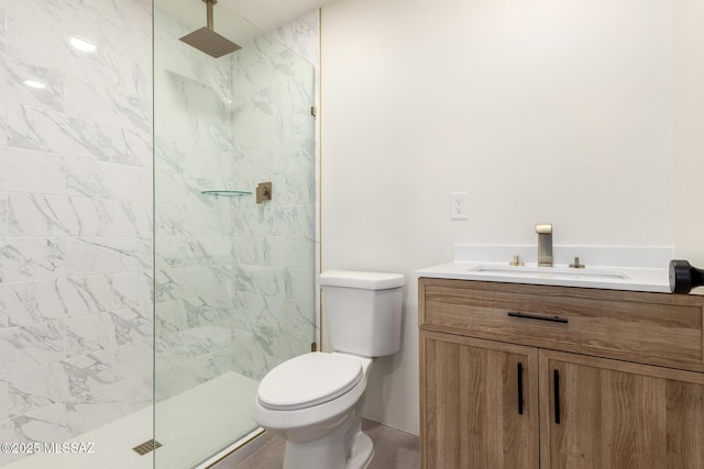 bathroom featuring toilet, vanity, and a walk in shower