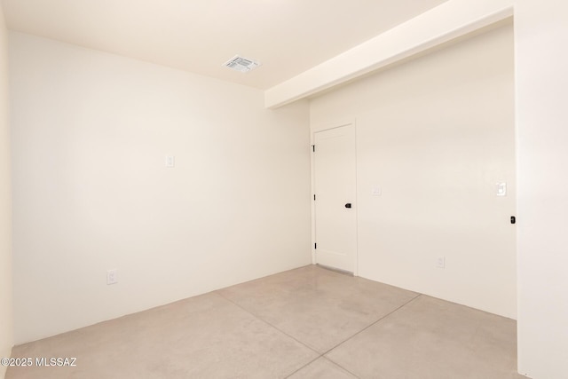 empty room with visible vents and concrete floors