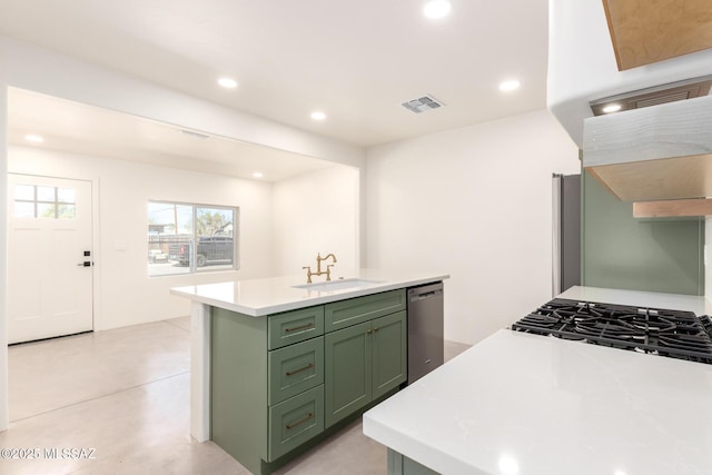 kitchen with visible vents, green cabinets, light countertops, stainless steel dishwasher, and a sink