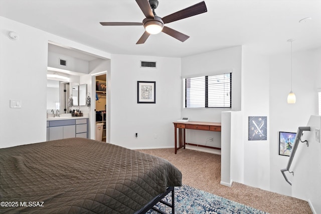 bedroom with a sink, visible vents, carpet floors, and ensuite bathroom