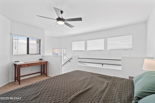 carpeted bedroom with baseboards and ceiling fan