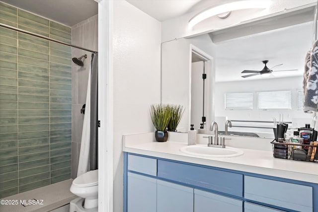 bathroom featuring tiled shower, toilet, vanity, and a ceiling fan