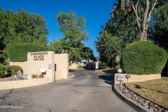 view of street featuring curbs and a gated entry