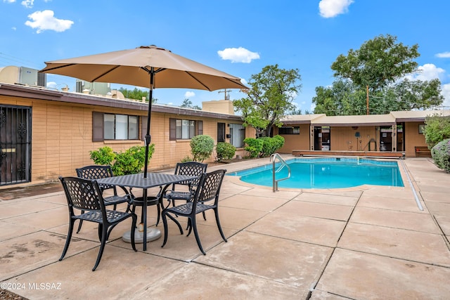 outdoor pool with a patio area