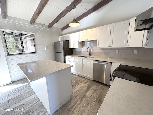 kitchen with a sink, lofted ceiling with beams, backsplash, stainless steel appliances, and extractor fan