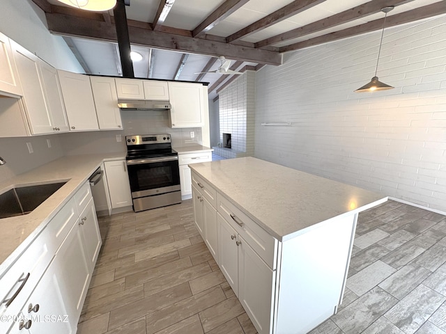 kitchen with under cabinet range hood, lofted ceiling with beams, white cabinets, stainless steel appliances, and a sink