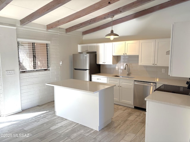 kitchen featuring tasteful backsplash, light wood-style flooring, appliances with stainless steel finishes, white cabinets, and a sink