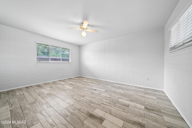 spare room with wood finished floors and ceiling fan