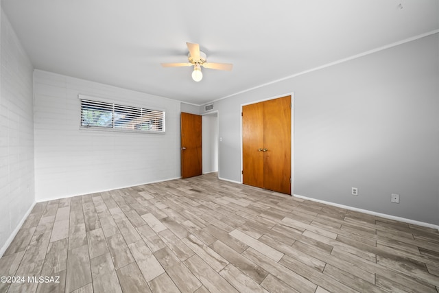 unfurnished room with wood finished floors, visible vents, and ceiling fan