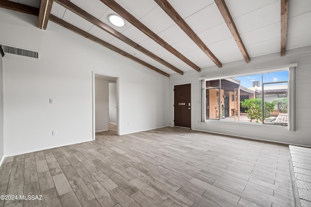 unfurnished living room with visible vents, high vaulted ceiling, beamed ceiling, and wood finished floors