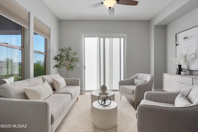 living room featuring light wood-style flooring and ceiling fan