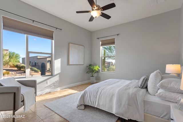 tiled bedroom with visible vents, baseboards, and ceiling fan