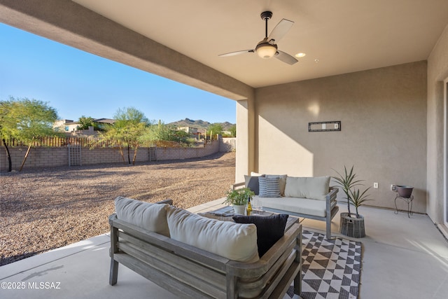 view of patio / terrace featuring outdoor lounge area, a ceiling fan, and a fenced backyard