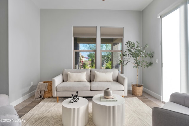 living area with wood finished floors and baseboards