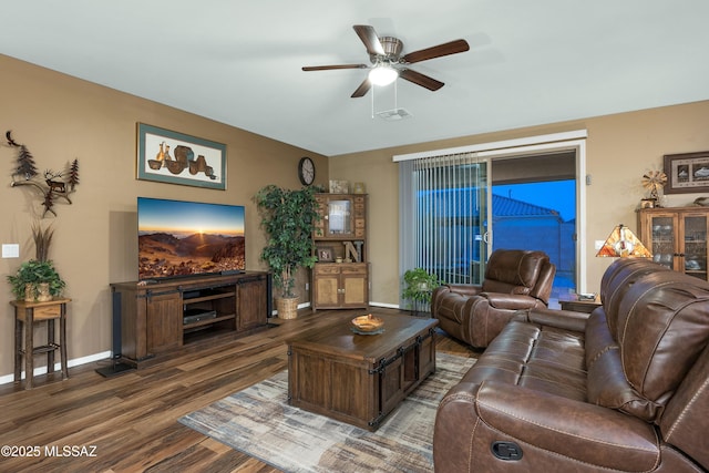 living area featuring ceiling fan, visible vents, baseboards, and wood finished floors