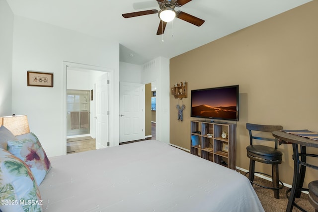 bedroom with ceiling fan, baseboards, and ensuite bath