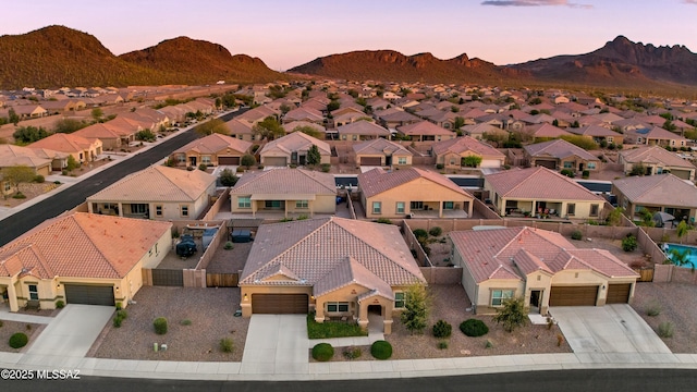 aerial view at dusk with a residential view and a mountain view