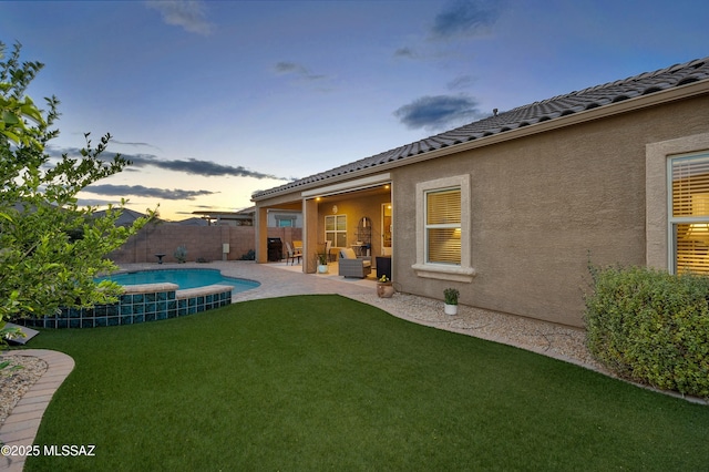 yard at dusk with a patio area, a fenced in pool, and a fenced backyard