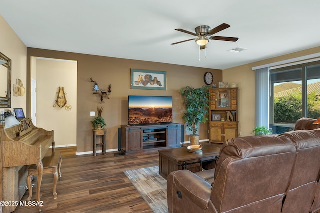 living room featuring visible vents, baseboards, dark wood finished floors, and a ceiling fan