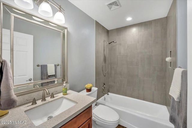 full bath with visible vents, toilet, shower / tub combination, and vanity