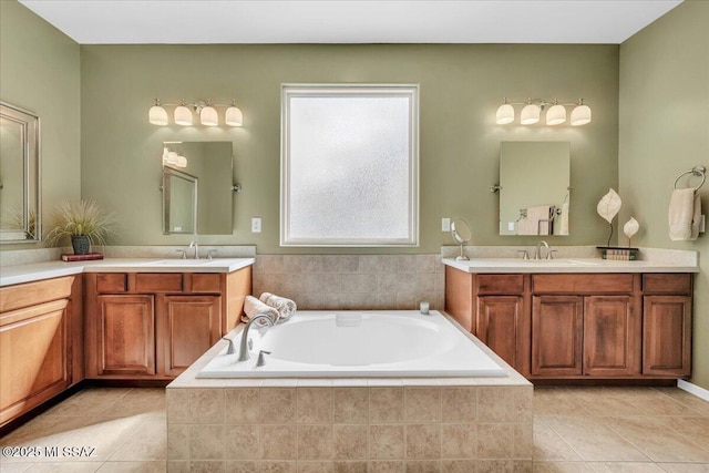 bathroom with a sink, tile patterned floors, two vanities, and a bath