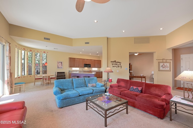 living room featuring recessed lighting, visible vents, light carpet, and ceiling fan