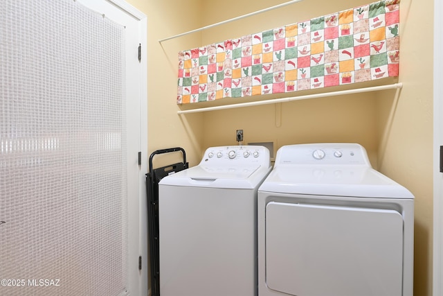 laundry area featuring separate washer and dryer and laundry area