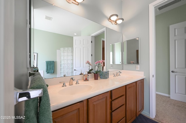 bathroom featuring a sink, visible vents, and double vanity