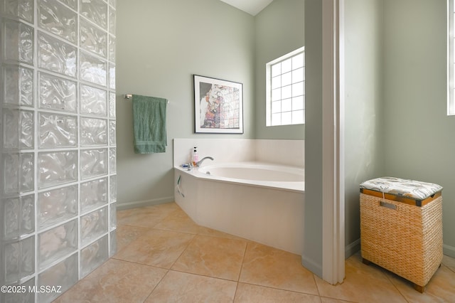 full bath featuring tile patterned floors, baseboards, and a bath