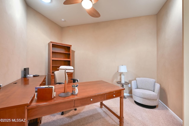 home office with baseboards, ceiling fan, and carpet flooring