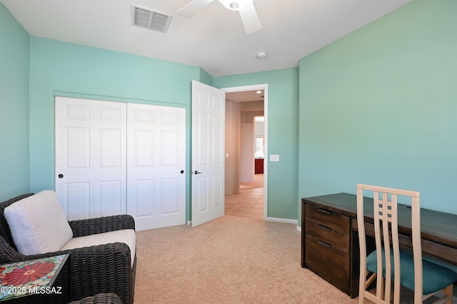 interior space featuring visible vents, light carpet, baseboards, and a ceiling fan