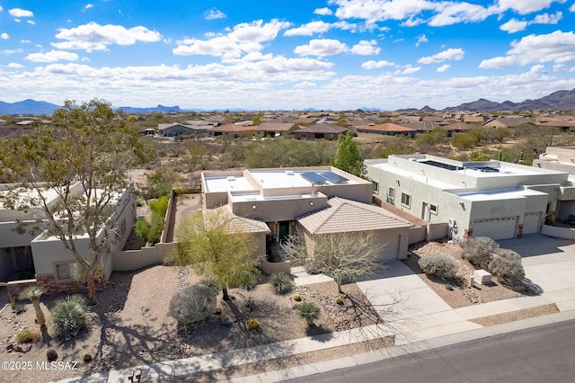 birds eye view of property featuring a mountain view and a residential view