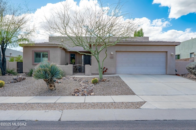 single story home featuring a garage, concrete driveway, and stucco siding