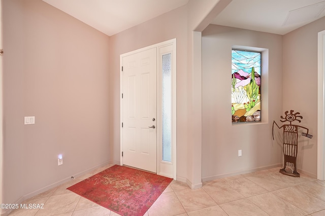 tiled foyer with baseboards